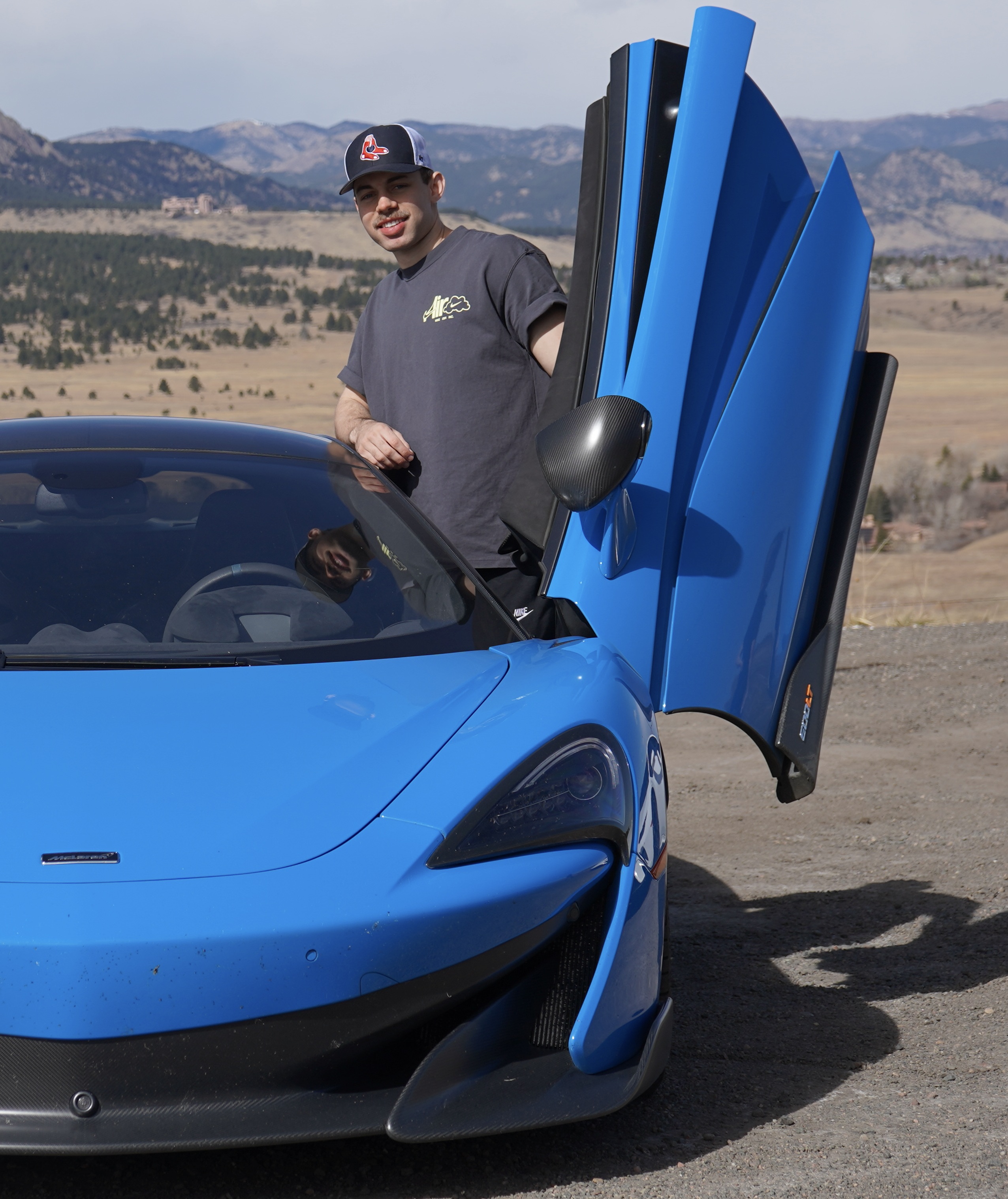 Jack at the open door of a McLaren 600LT in the Colorado foothills